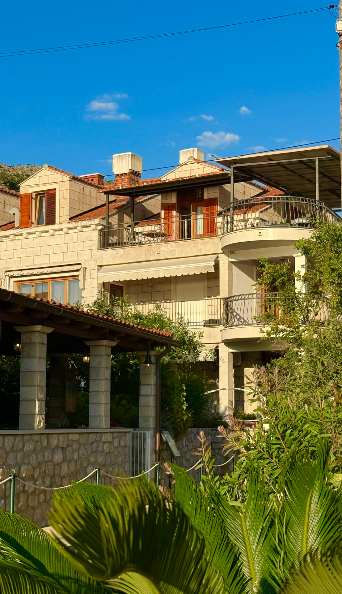 The stone villa and shaded patio at Wild Orange Dubrovnik