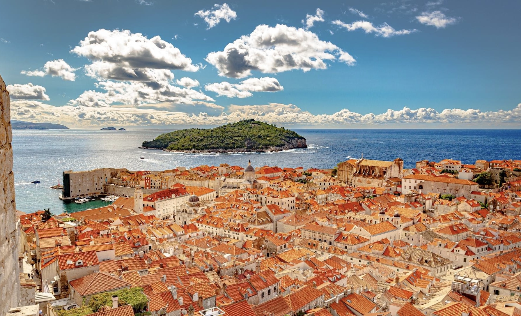 Dubrovnik Old Town rooftops and the old port, with Lokrum Island across the Adriatic